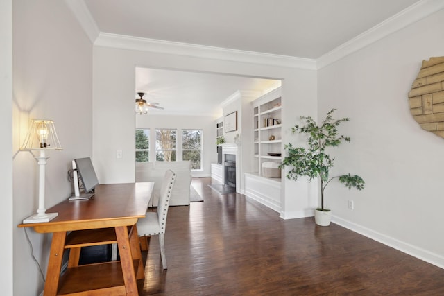 dining space featuring built in shelves, dark wood-type flooring, ornamental molding, and ceiling fan