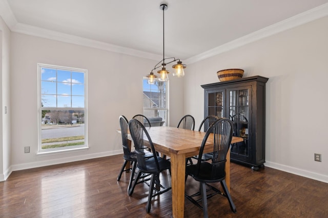 dining space with crown molding, plenty of natural light, and dark hardwood / wood-style floors