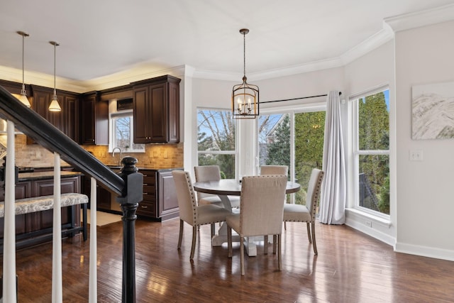 dining area featuring crown molding, dark hardwood / wood-style floors, a chandelier, and a wealth of natural light