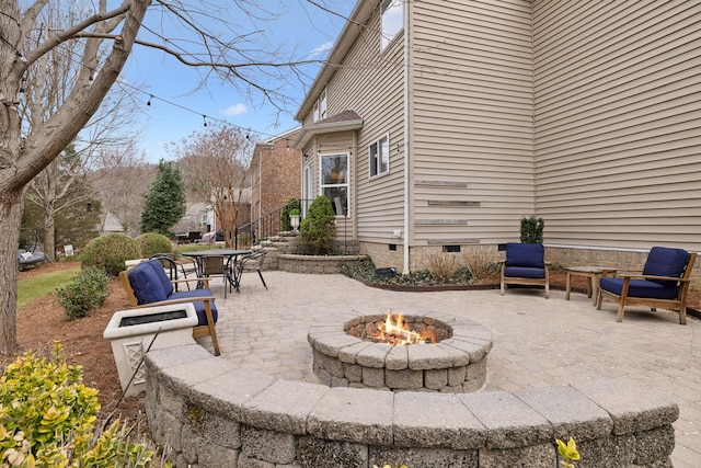 view of patio / terrace featuring an outdoor fire pit