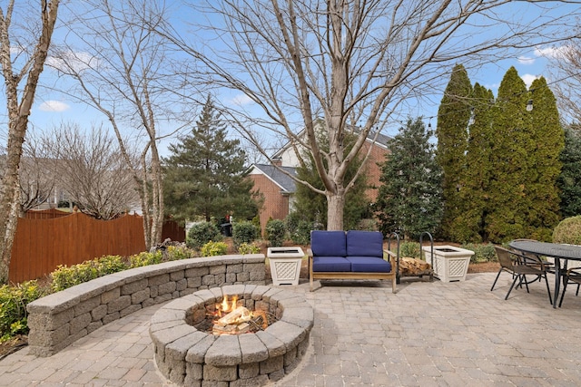 view of patio / terrace with an outdoor living space with a fire pit