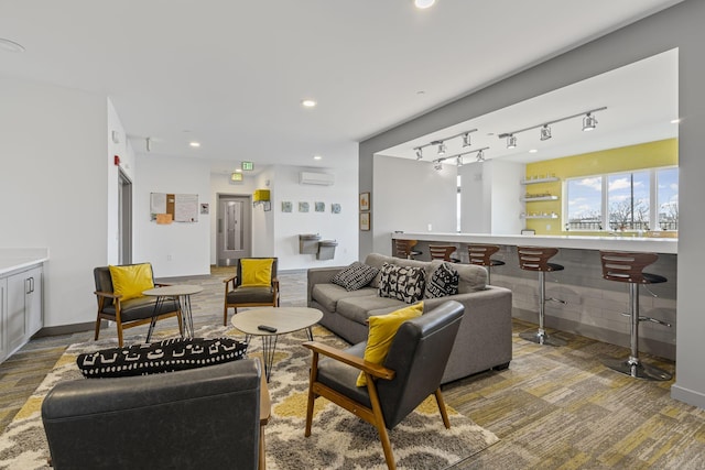 living room featuring a wall unit AC, rail lighting, and bar area