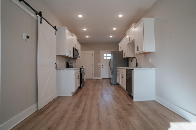 kitchen featuring white cabinetry and appliances with stainless steel finishes