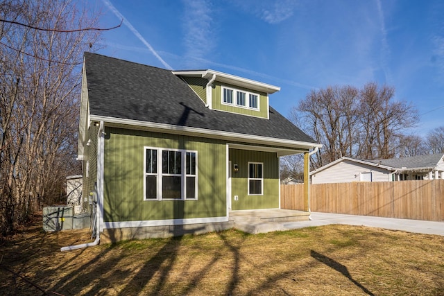 back of house featuring a patio area and a lawn