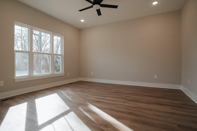 empty room featuring hardwood / wood-style flooring and ceiling fan