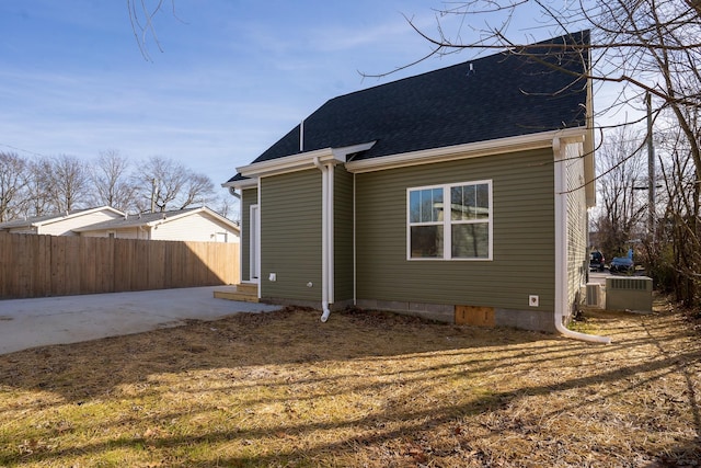 back of property with a yard and a patio area