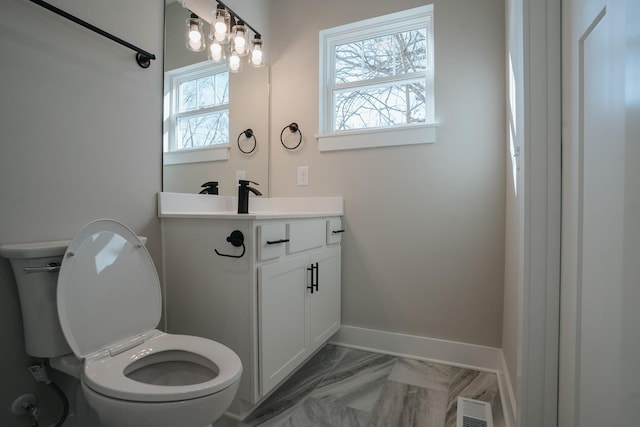 bathroom featuring vanity and toilet