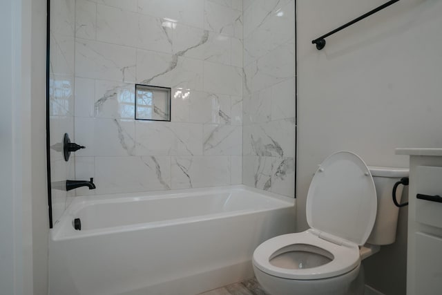 bathroom featuring tiled shower / bath and toilet