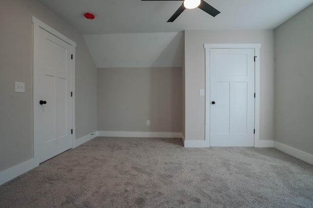 additional living space with ceiling fan, vaulted ceiling, and light carpet