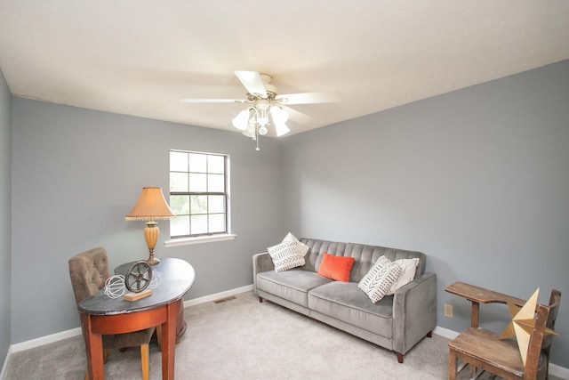 carpeted living room featuring ceiling fan