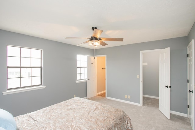 bedroom featuring light carpet and ceiling fan