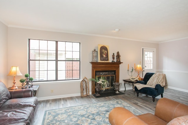 living room with hardwood / wood-style flooring and crown molding