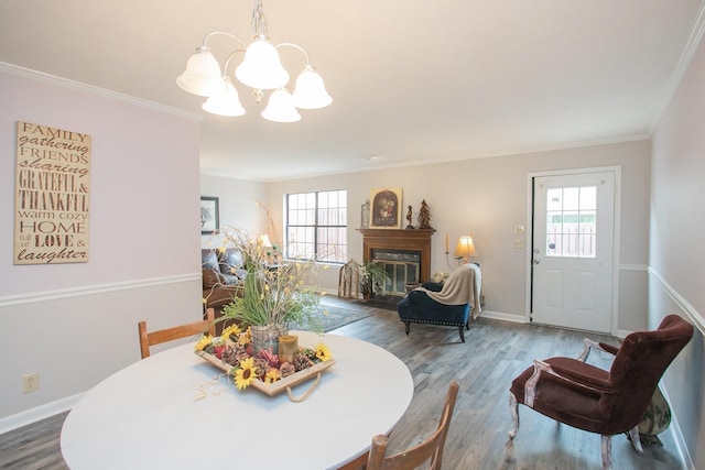 dining space with hardwood / wood-style flooring, ornamental molding, and a healthy amount of sunlight