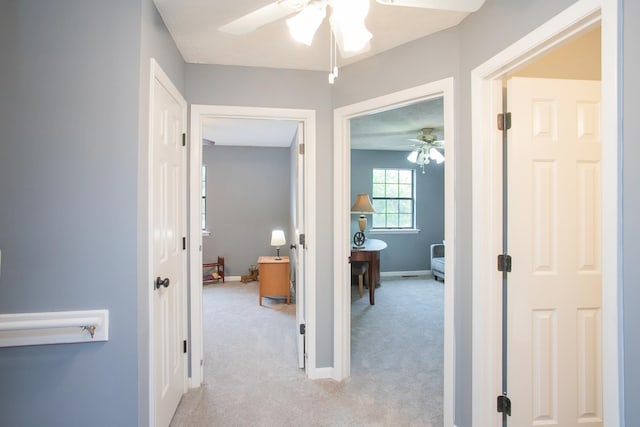 corridor featuring light colored carpet