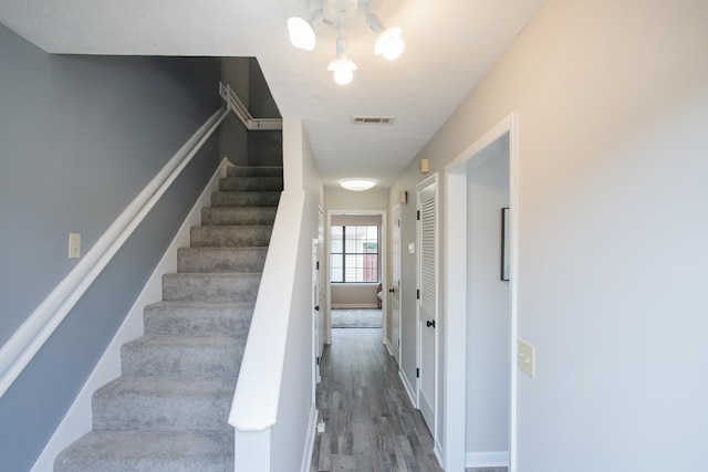 stairs featuring wood-type flooring