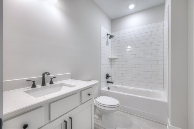 full bathroom featuring tiled shower / bath combo, vanity, tile patterned floors, and toilet