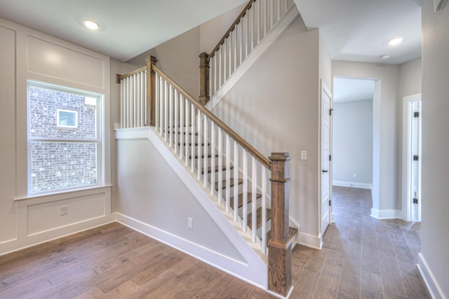 stairway featuring hardwood / wood-style flooring and plenty of natural light