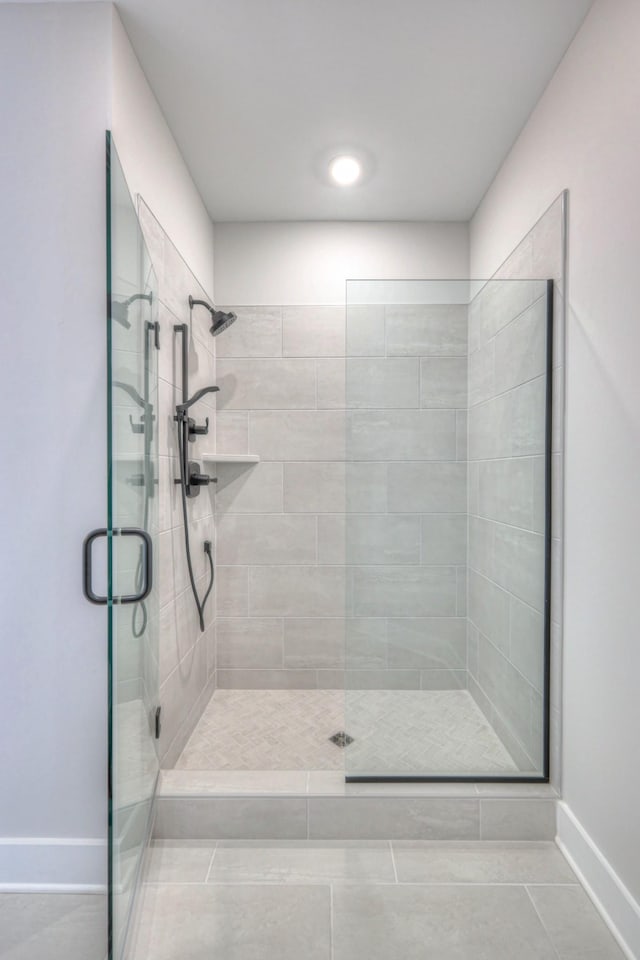 bathroom featuring tile patterned floors and a shower with door