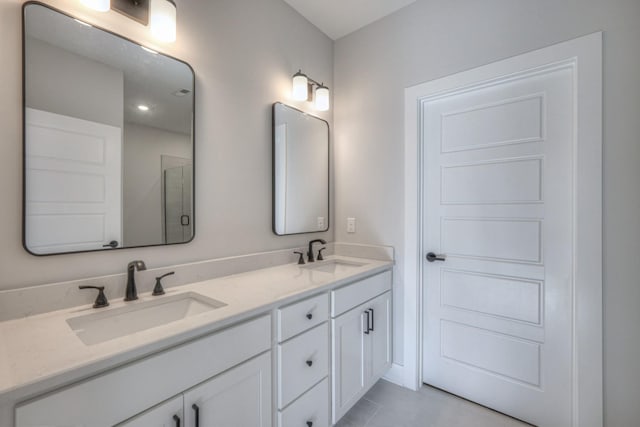 bathroom with vanity, tile patterned flooring, and a shower with door