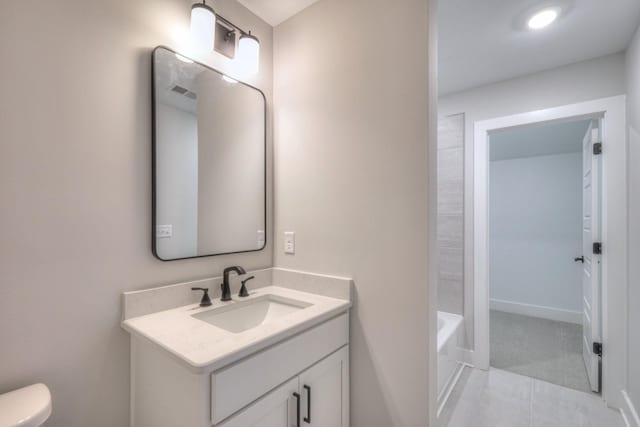 bathroom with vanity, tile patterned floors, and toilet