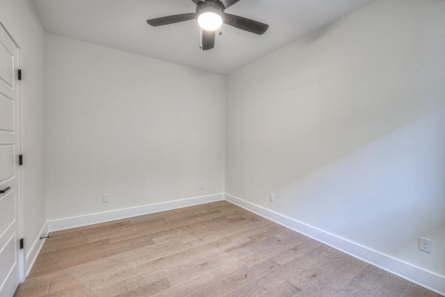 empty room with ceiling fan and light hardwood / wood-style floors