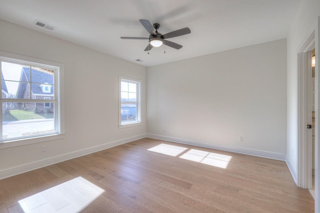 empty room featuring ceiling fan and light hardwood / wood-style flooring