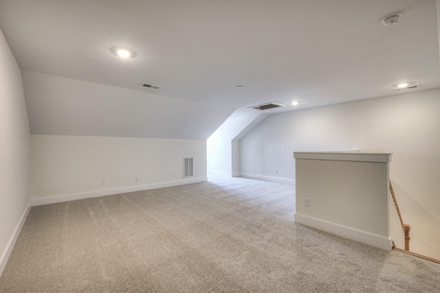 bonus room featuring vaulted ceiling and light carpet