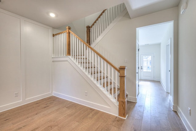 stairway with hardwood / wood-style flooring