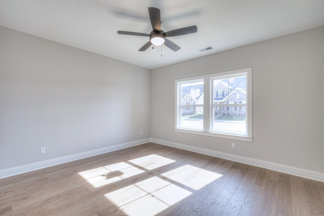 spare room with ceiling fan and light wood-type flooring