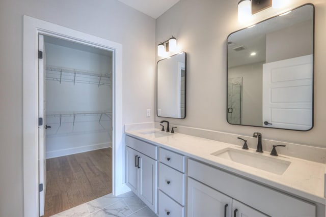 bathroom with vanity and a shower with shower door