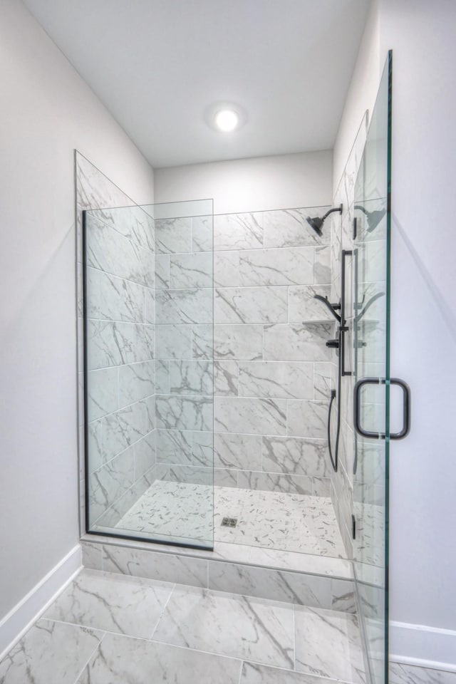 bathroom featuring a shower with shower door