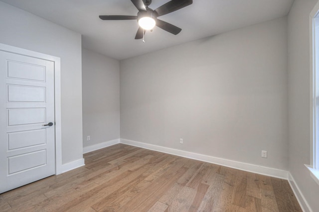 empty room with ceiling fan and light wood-type flooring