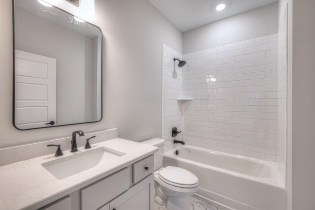 full bathroom featuring vanity, toilet, and tiled shower / bath combo