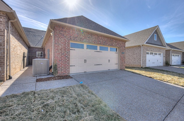 view of home's exterior with cooling unit and a garage