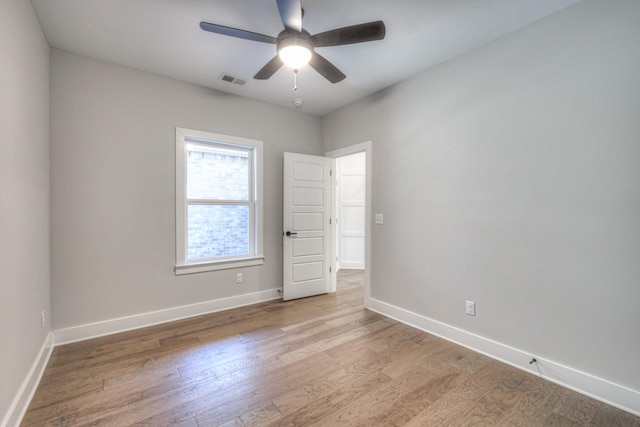 unfurnished room with ceiling fan and light hardwood / wood-style flooring