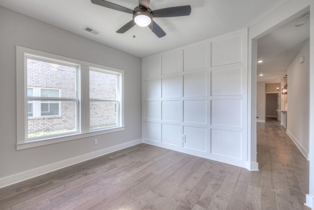 unfurnished room featuring ceiling fan and light wood-type flooring