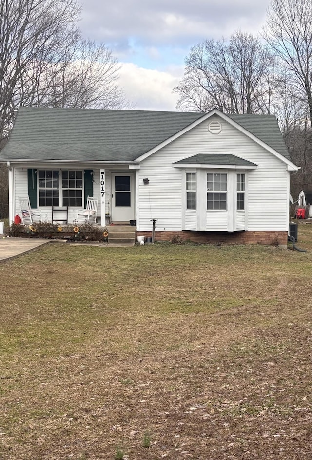 ranch-style house with a front lawn and a porch