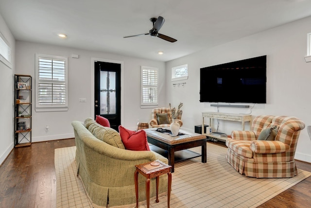 living room featuring wood-type flooring and ceiling fan