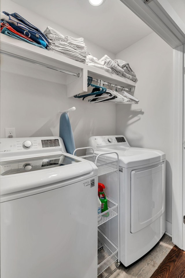 laundry room with dark hardwood / wood-style flooring and independent washer and dryer