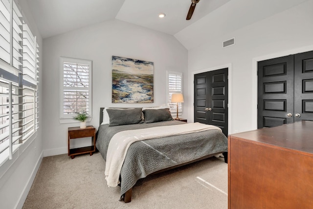 carpeted bedroom with ceiling fan and vaulted ceiling