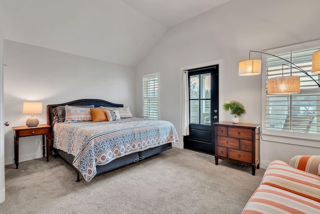 bedroom with light colored carpet and vaulted ceiling