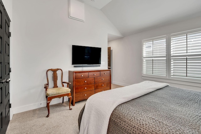 bedroom with lofted ceiling and light carpet