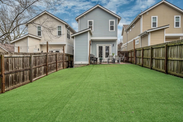 rear view of property with a patio area and a lawn