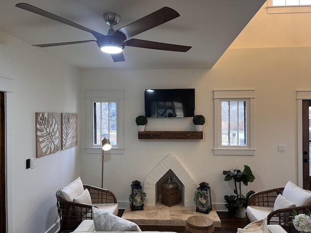 living room with hardwood / wood-style flooring, ceiling fan, and plenty of natural light