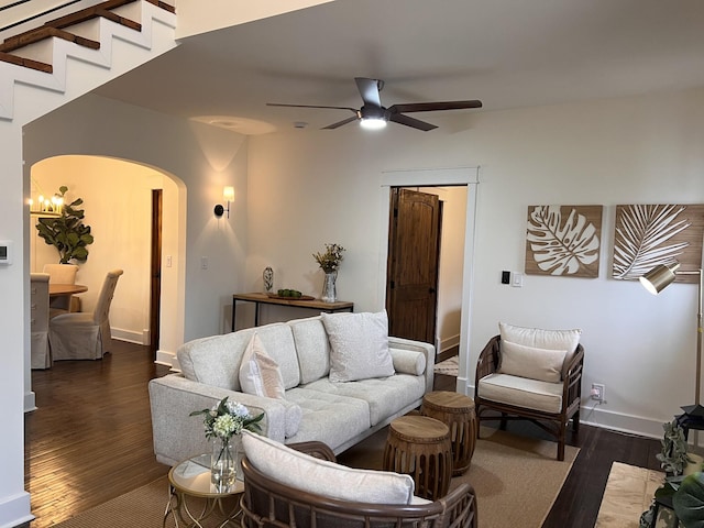 living room with ceiling fan and dark hardwood / wood-style flooring