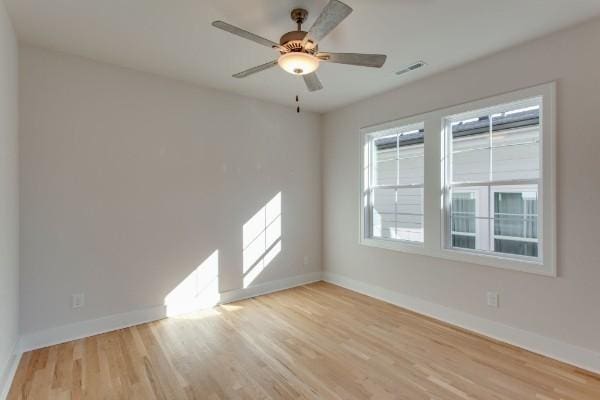 spare room with ceiling fan and light hardwood / wood-style floors