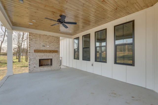 view of patio / terrace featuring an outdoor brick fireplace and ceiling fan