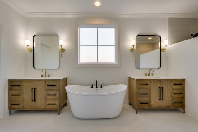 bathroom with vanity, ornamental molding, and a tub