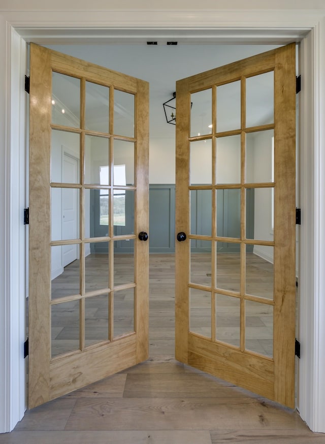 doorway featuring wood-type flooring and french doors