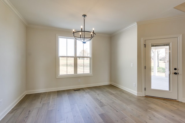 unfurnished dining area featuring crown molding, plenty of natural light, and light hardwood / wood-style floors